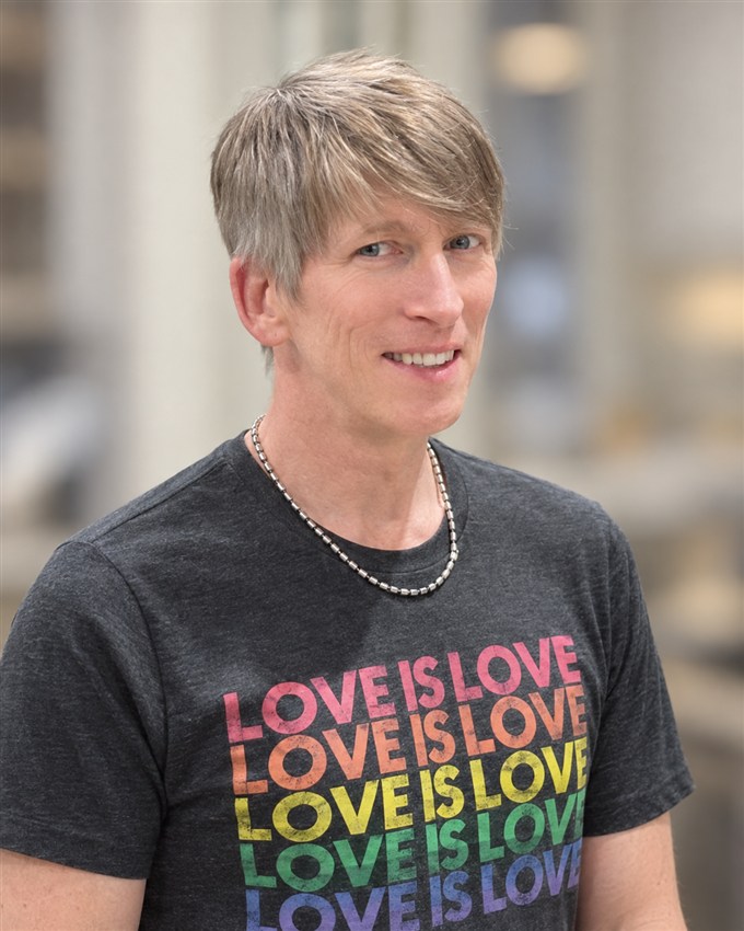 Rodney smiling in his Love Is Love shirt